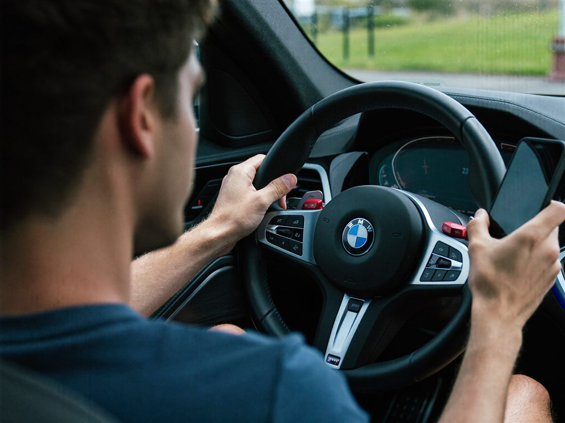 Distracted driving holding the phone by hand